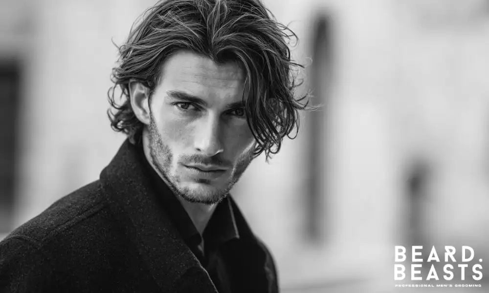 Man with fine, straight-to-wavy hair styled using mousse for volume, lift, and structured movement.