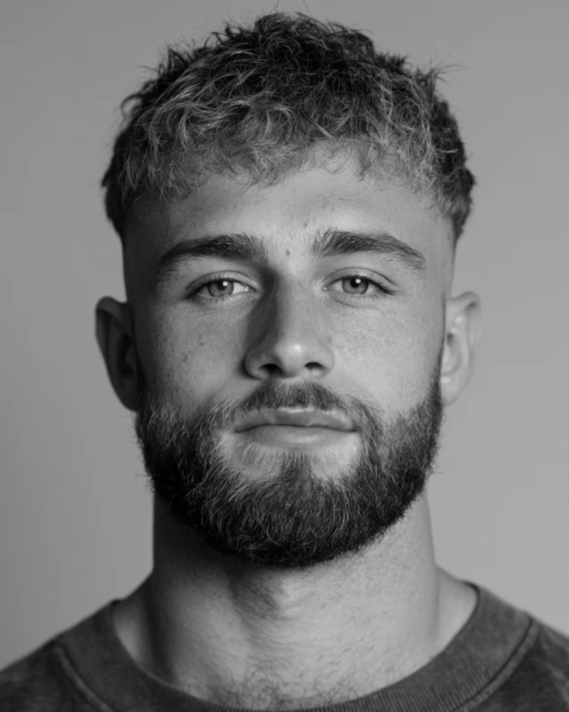 Confident man with a full shaped beard showing how facial hair can improve comfort with his appearance