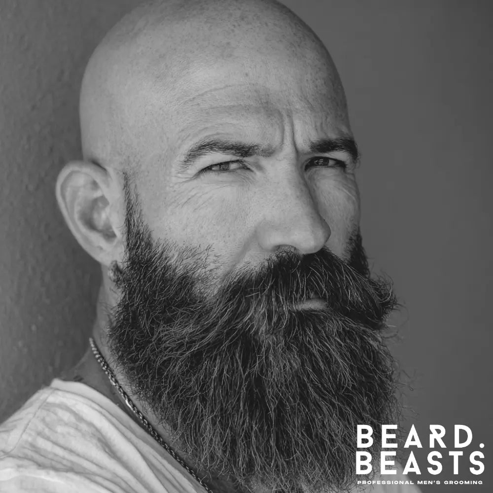 Man with a thick, full Garibaldi beard featuring a wide rounded bottom and blended moustache, a flattering beard style for a heart-shaped face