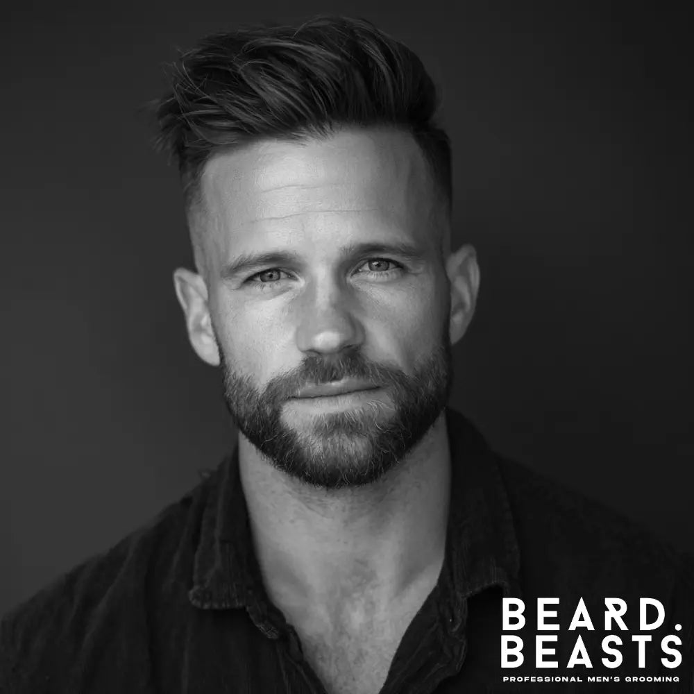 Man with a neatly trimmed short boxed beard and tapered sides, a balanced beard style ideal for men with a heart-shaped face