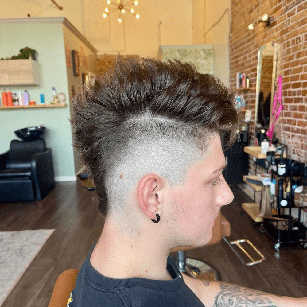High Fade Mohawk featuring a spiky, voluminous top and a dramatic high fade on the sides.