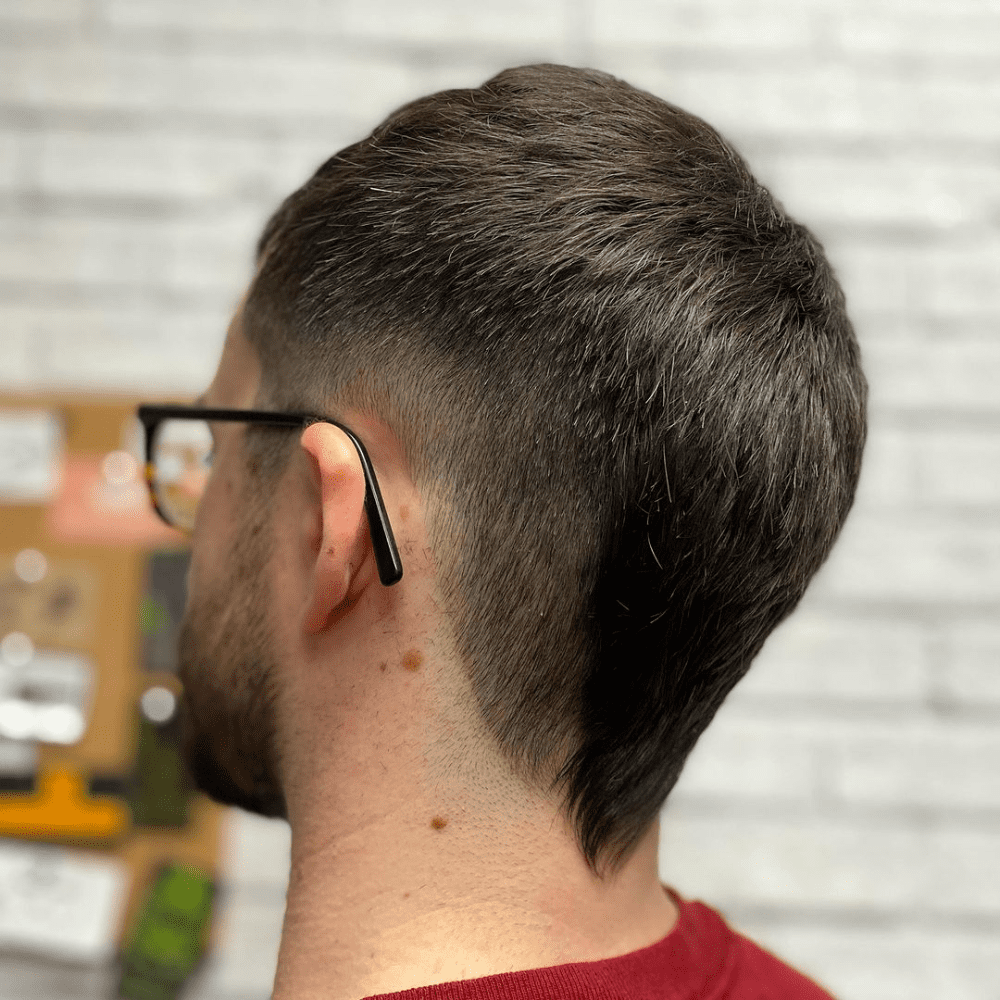 Short Mohawk Fade with a neatly tapered top and a clean, subtle fade on the lower sides and nape.