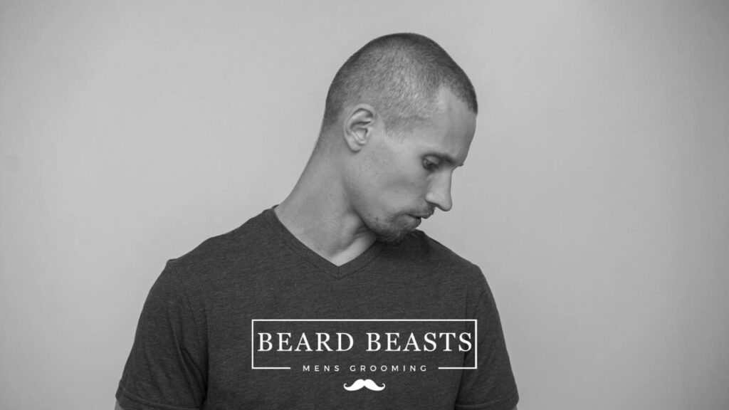Side profile of a man sporting a fresh number 2 buzz cut for Beard Beasts men's grooming advertisement