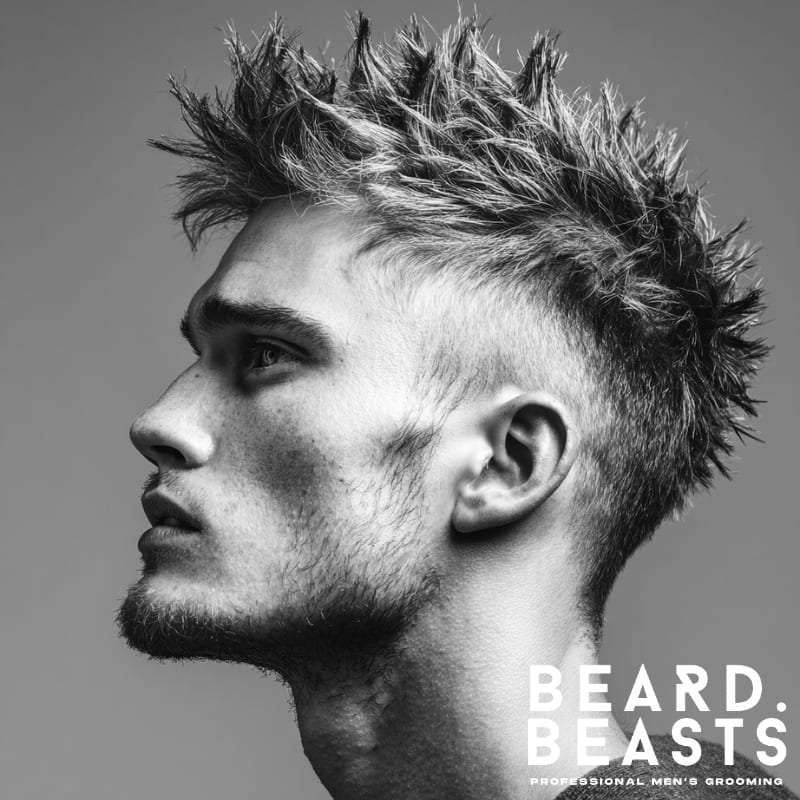 A bold faux hawk hairstyle for men with a diamond face shape, featuring spiked texture and volume that adds height and contrast. This edgy hairstyle works well with angular features, providing a sharp and dynamic look that enhances the facial structure of men with a diamond-shaped face.