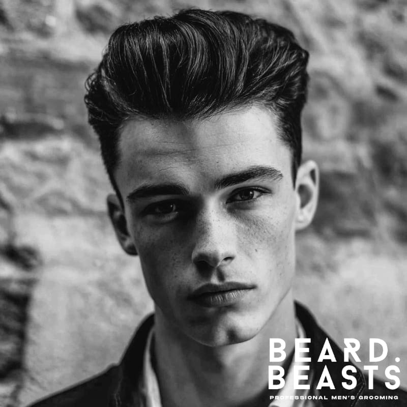 A stylish pompadour hairstyle for men with a diamond face shape, featuring voluminous height and sharp lines that complement angular features. This pompadour adds structure and balance, making it a perfect choice for men with a diamond-shaped face, enhancing their facial symmetry with a bold, modern look.