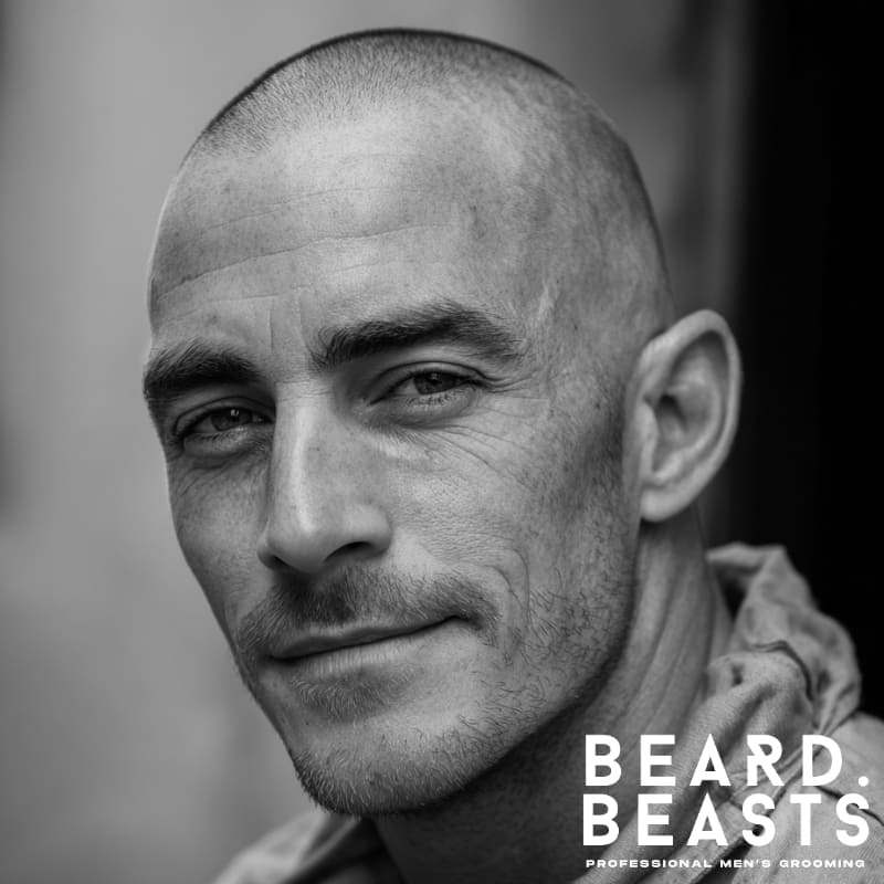 Induction cut military haircut for men, featuring a closely shaved, uniform buzz cut with faded sides. This low-maintenance, sharp style is ideal for those seeking a clean, military-inspired look that is easy to maintain and exudes strength and discipline.