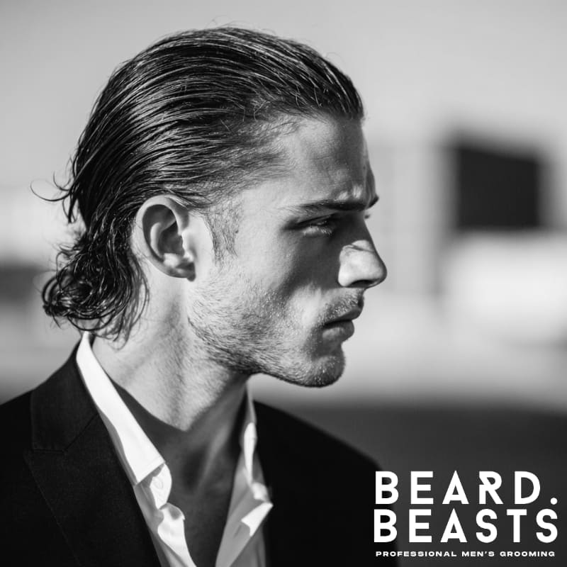 A sharp, formal look featuring long hair slicked back for a polished, sophisticated style. Ideal for men seeking a sleek, refined hairstyle that exudes professionalism and elegance, perfect for formal occasions.