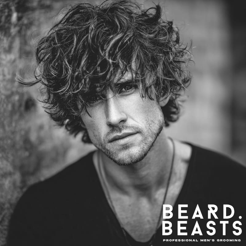 A modern, textured shag style with voluminous, wavy hair. Perfect for adding natural movement and depth, this shag haircut works best for curly or wavy hair types. Ideal for men seeking a bold, carefree look with effortless styling.