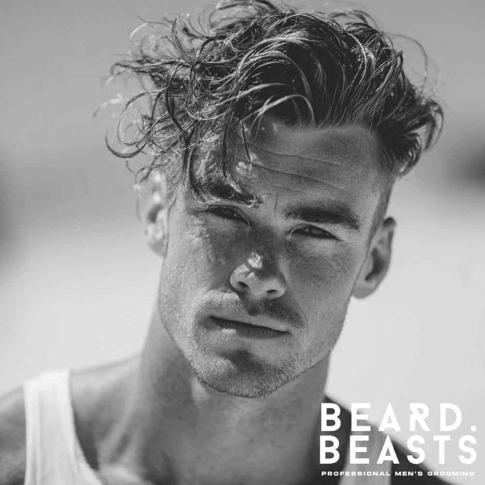 Man with messy side-swept undercut surfer hairstyle and textured top on the beach