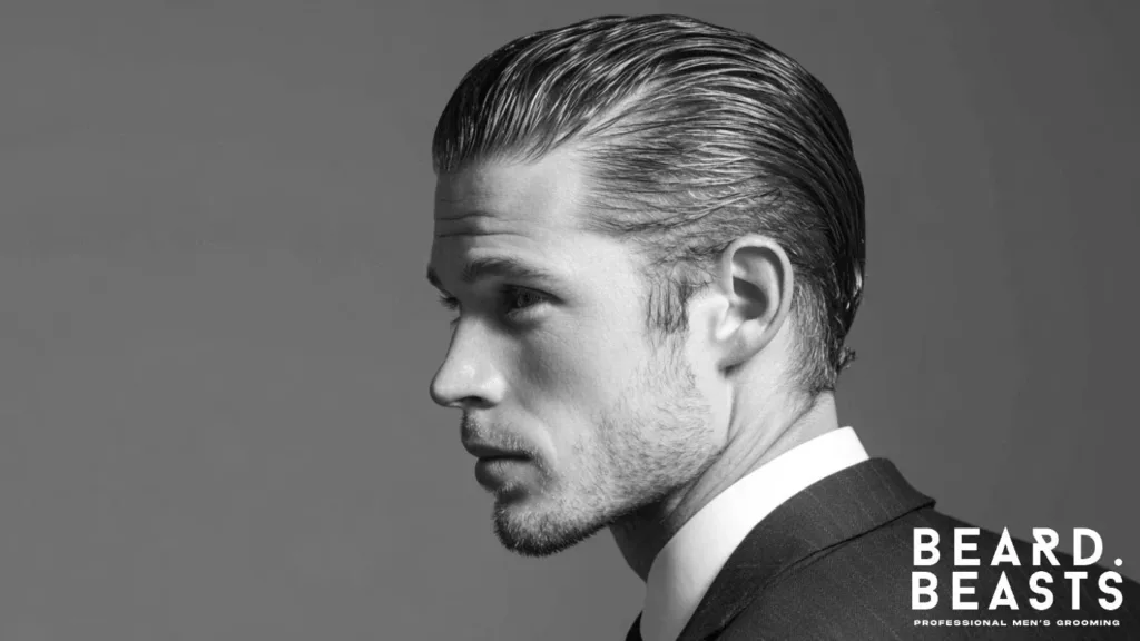 Classic Slicked Back Haircut featuring a polished professional look and groomed stubble