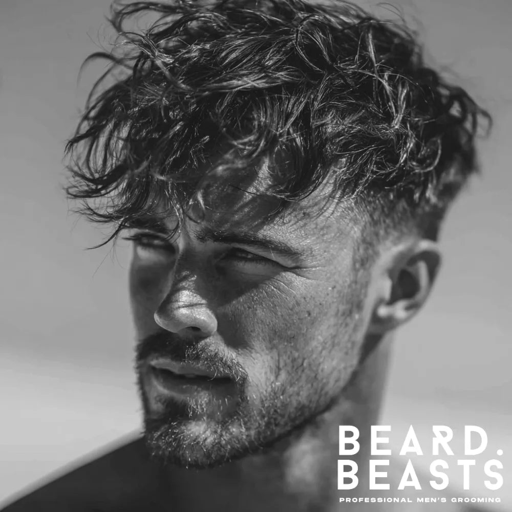 Man with textured crop and taper fade surfer hairstyle featuring messy top and natural movement
