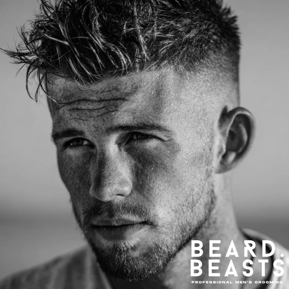 Man with textured skin fade surfer hairstyle featuring sharp sides and tousled top