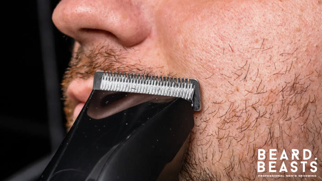 Close-up of a man trimming his 7mm beard with an electric trimmer for a clean and defined look