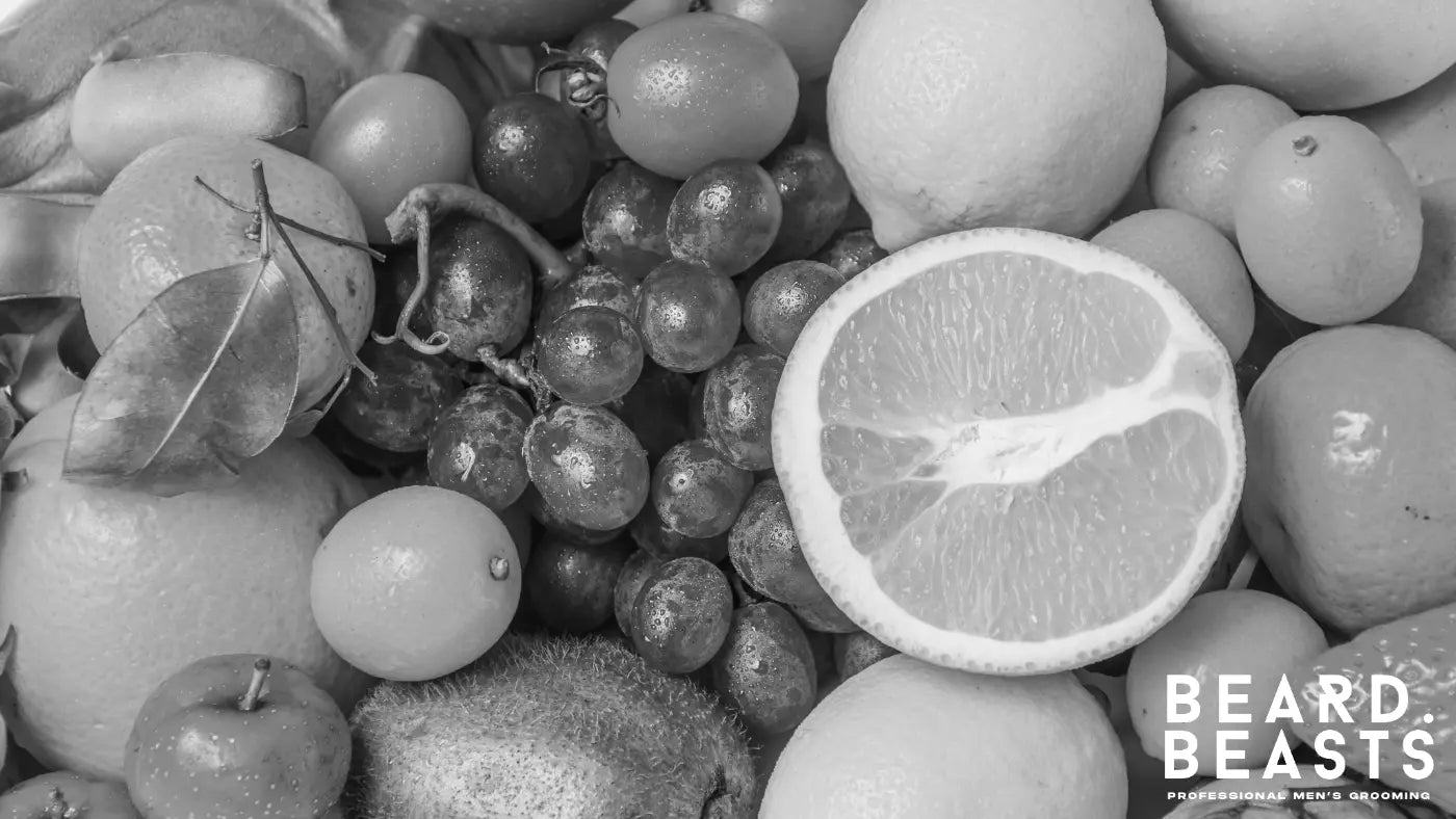 A variety of fresh fruits including oranges, grapes, lemons, kiwi, and apples that provide essential vitamins and nutrients to support healthy beard growth.