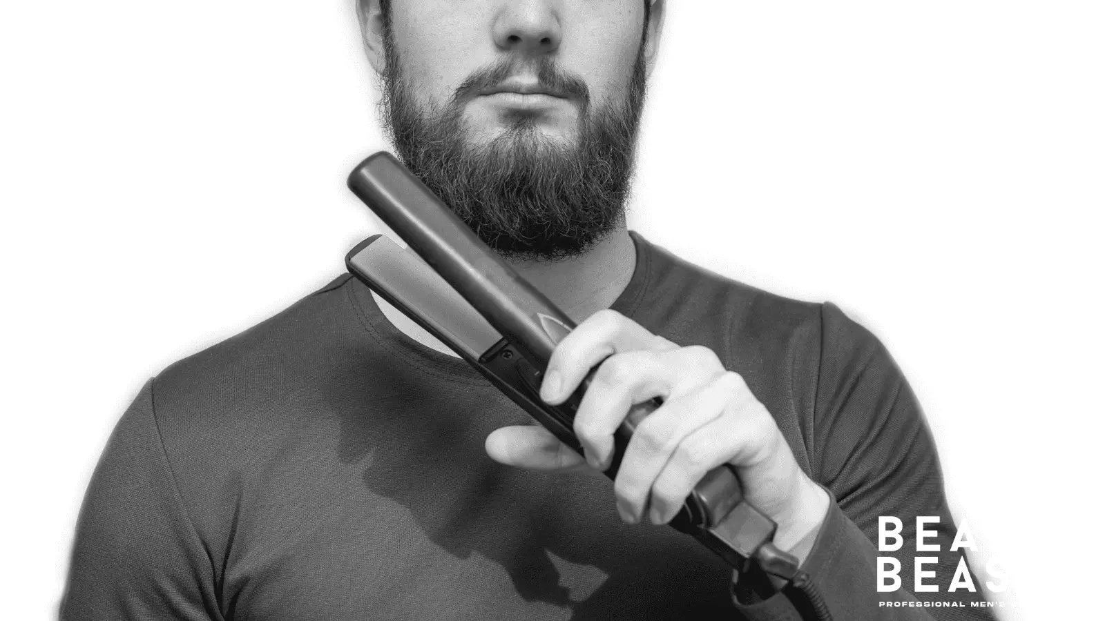 Do beard straighteners work on short beards? Man attempting to straighten a short beard with a flat iron.