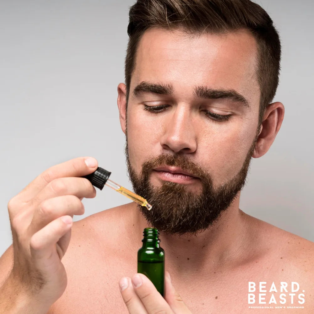 Man applying beard oil with dropper — showing how to choose the best beard oil for men based on beard type and skin needs.