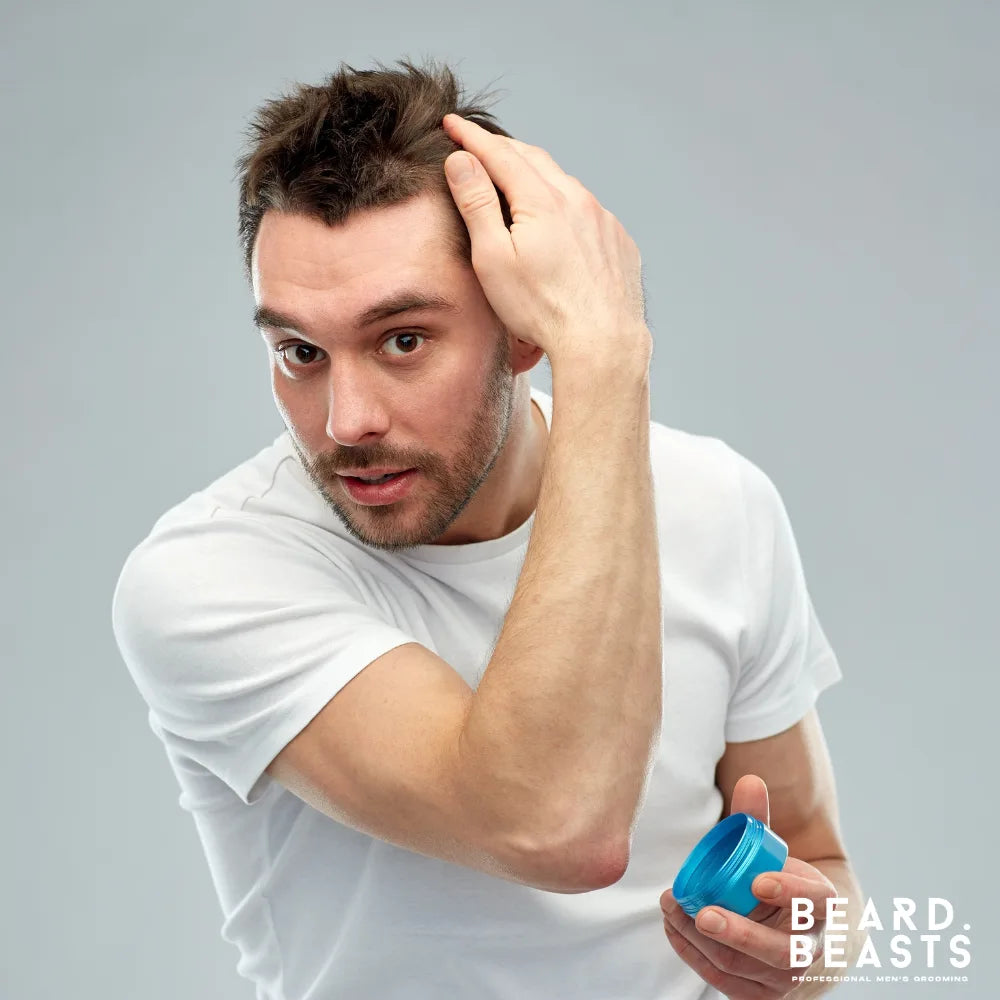 Man applying hair gel to style his hair — illustrating how to choose the right men’s hair gel for hold, finish, and texture.