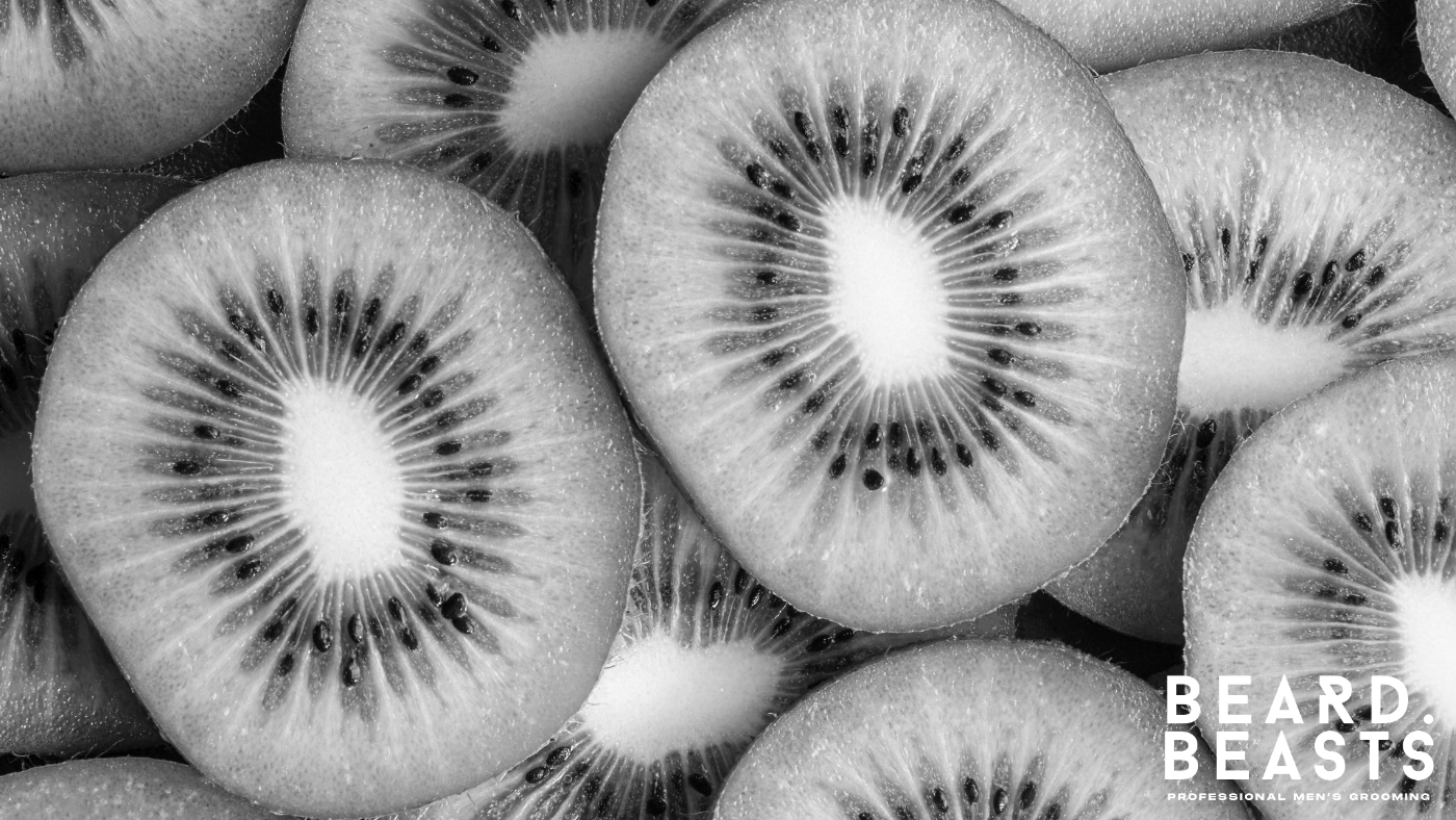Close-up of sliced kiwi fruit showing vibrant green texture, rich in vitamins C and E and antioxidants that protect follicles and support healthy beard growth.
