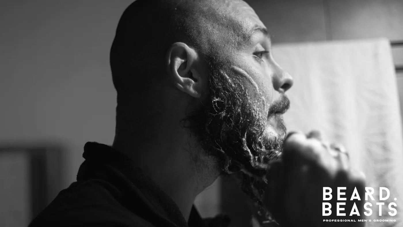 Man washing his beard with cleansing foam as part of a daily grooming routine.