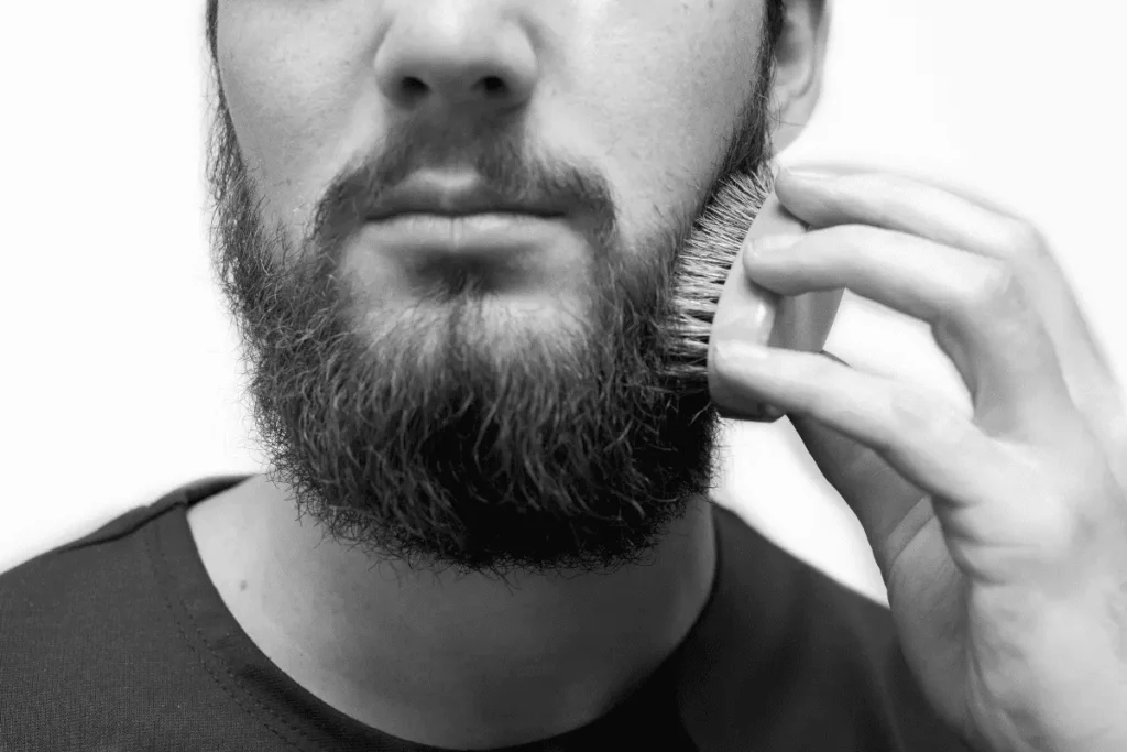 Man brushing beard to remove beard flakes without itch