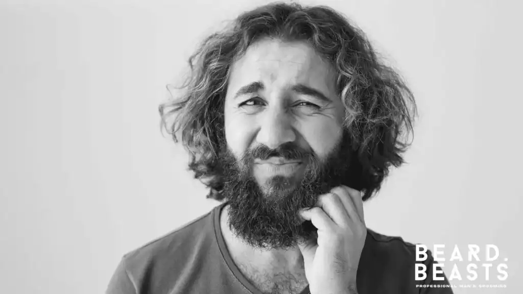 Man scratching an itchy beard due to irritation and beard itch