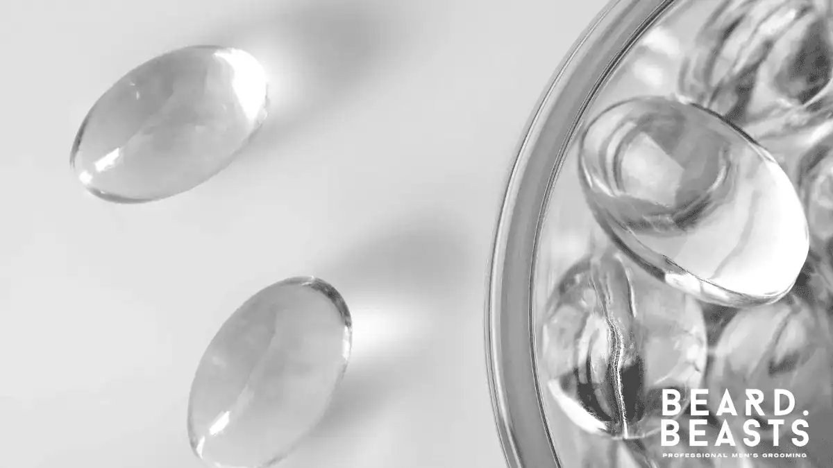 Golden liquid gel capsules containing vitamin e for beard growth and skin hydration.