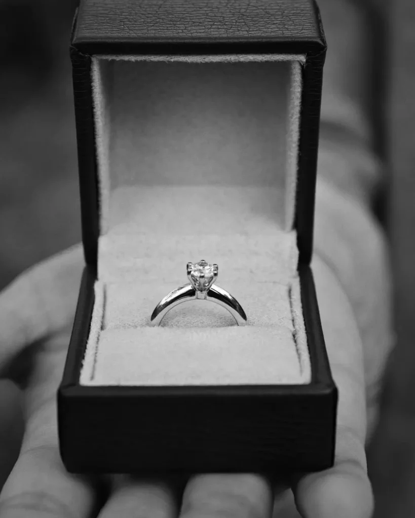 Diamond engagement ring presented in an open jewellery box before a proposal