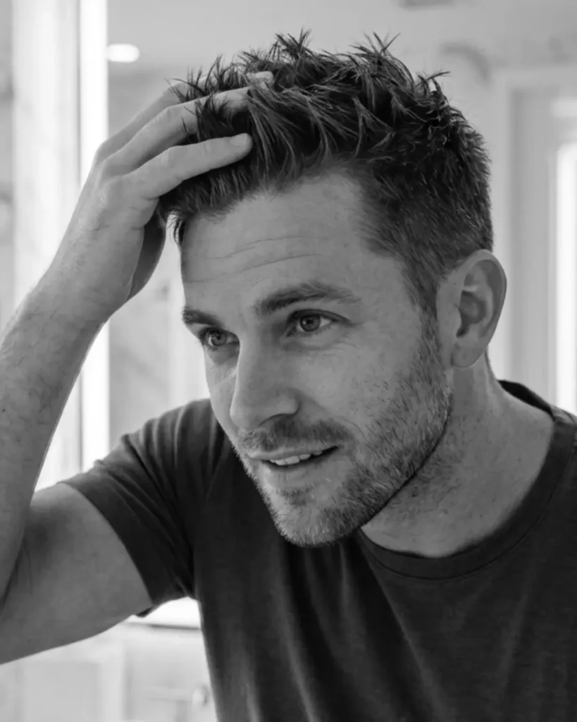 Man styling medium-length textured hair with hair paste, showing how paste gives flexible hold and easier restyling for everyday men’s hairstyles.