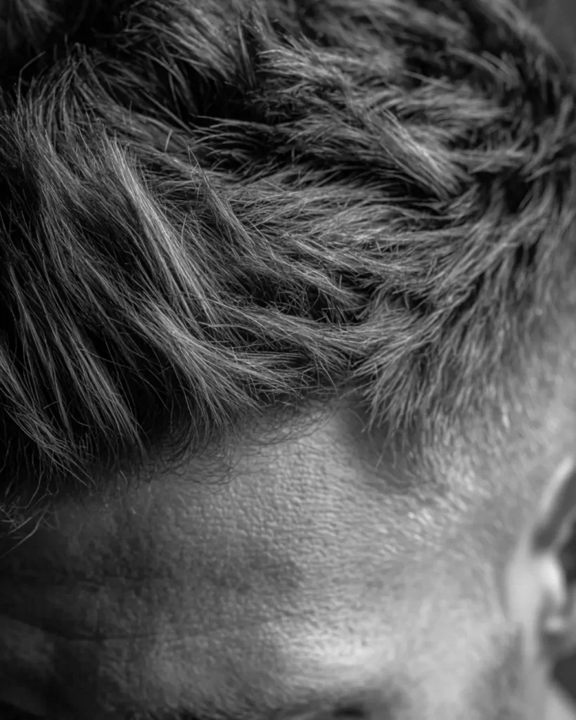 Close-up of textured men’s hair, showing how hair type and style affect whether hair wax or hair paste works better.
